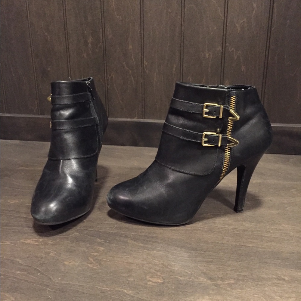Black leather ankle bootie with gold accents